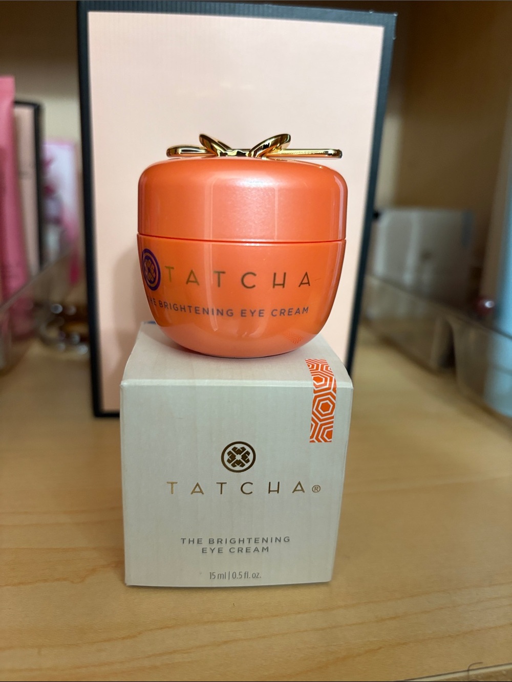 Tatcha Brightening Eye Cream Jar in Orange with Gold Bow Accent